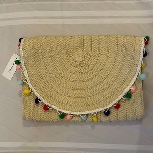 Straw purse with pom poms